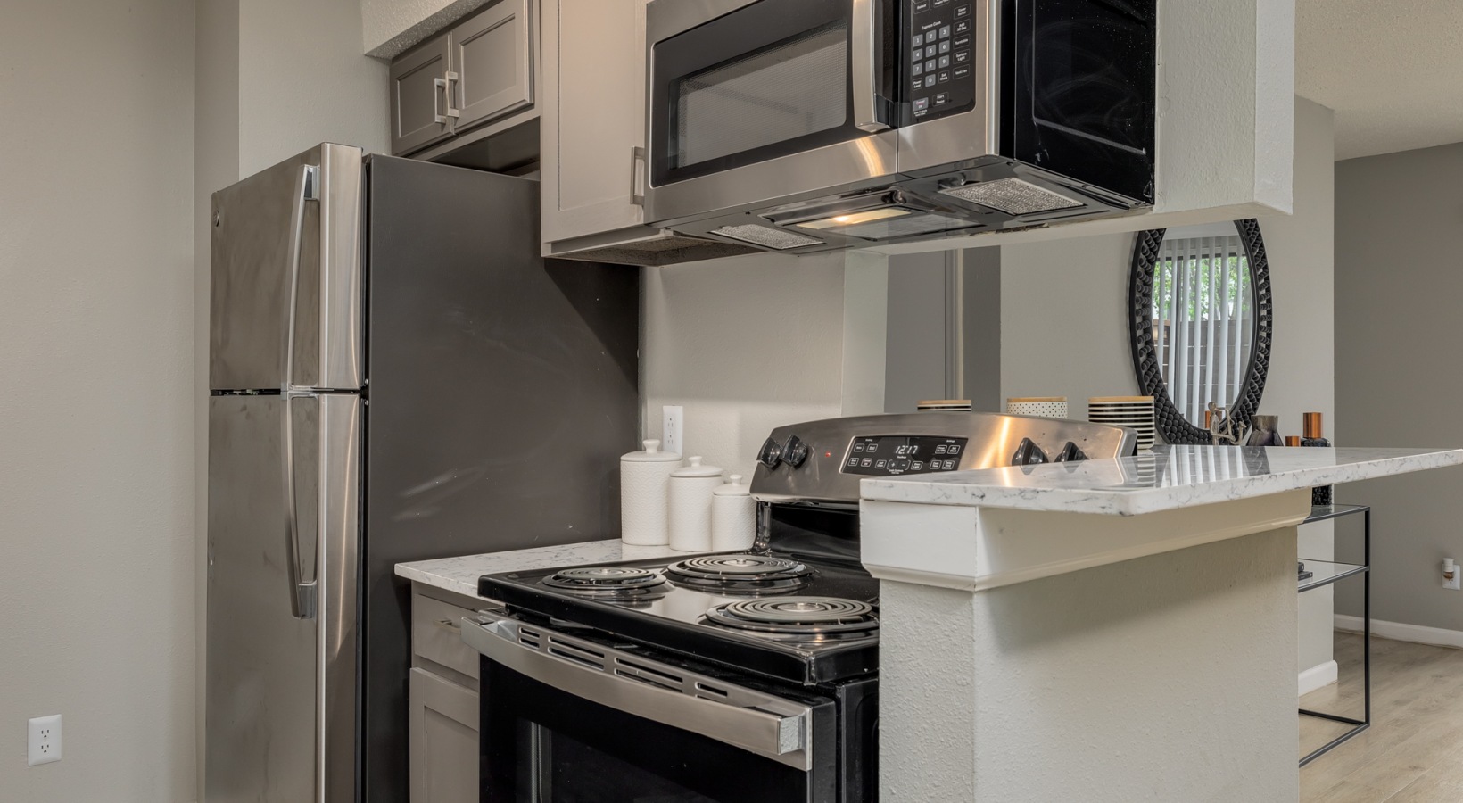 kitchen with stainless steel appliances and microwave oven at The  Tatum