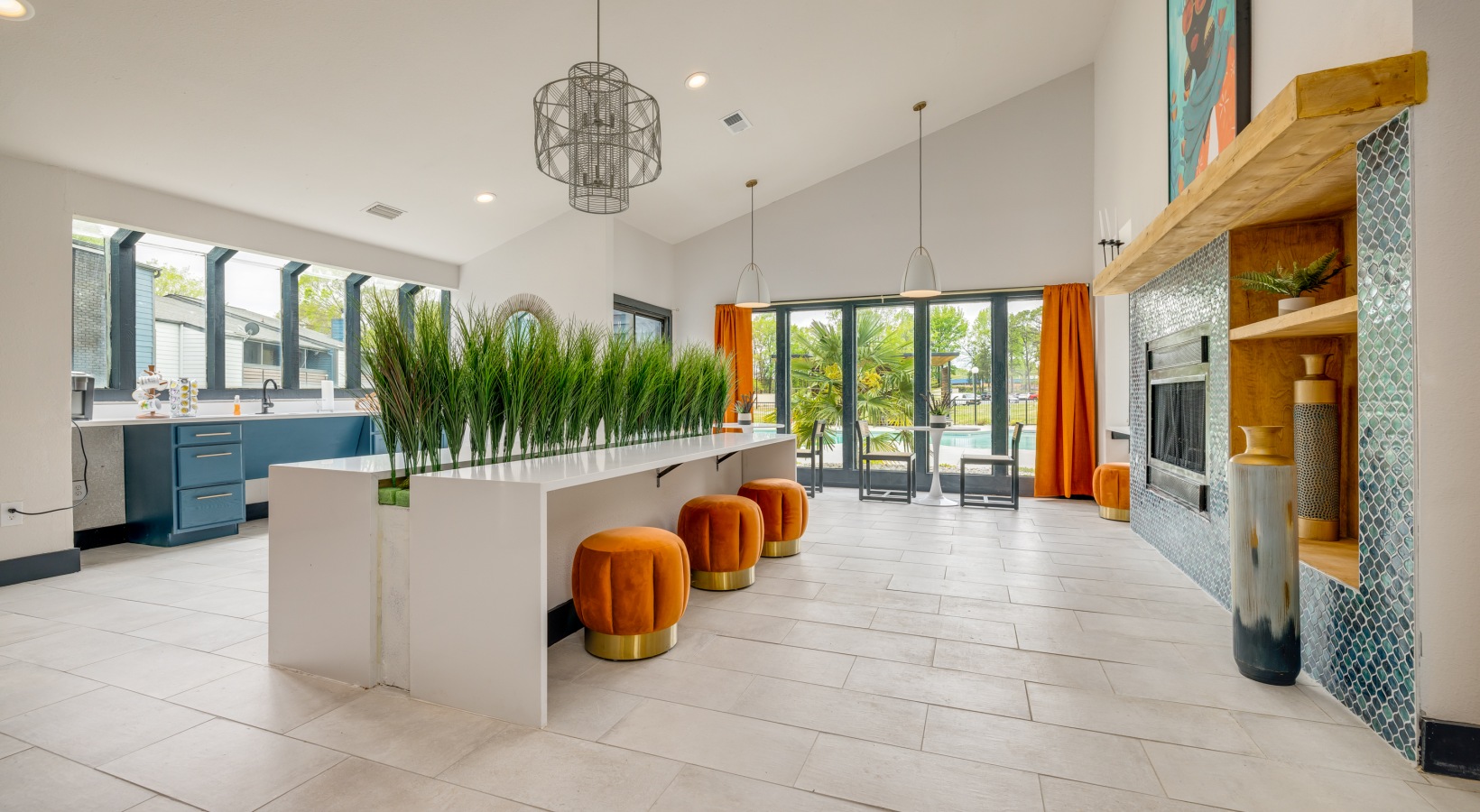 a large open kitchen with orange accents and a large dining area at The  Tatum