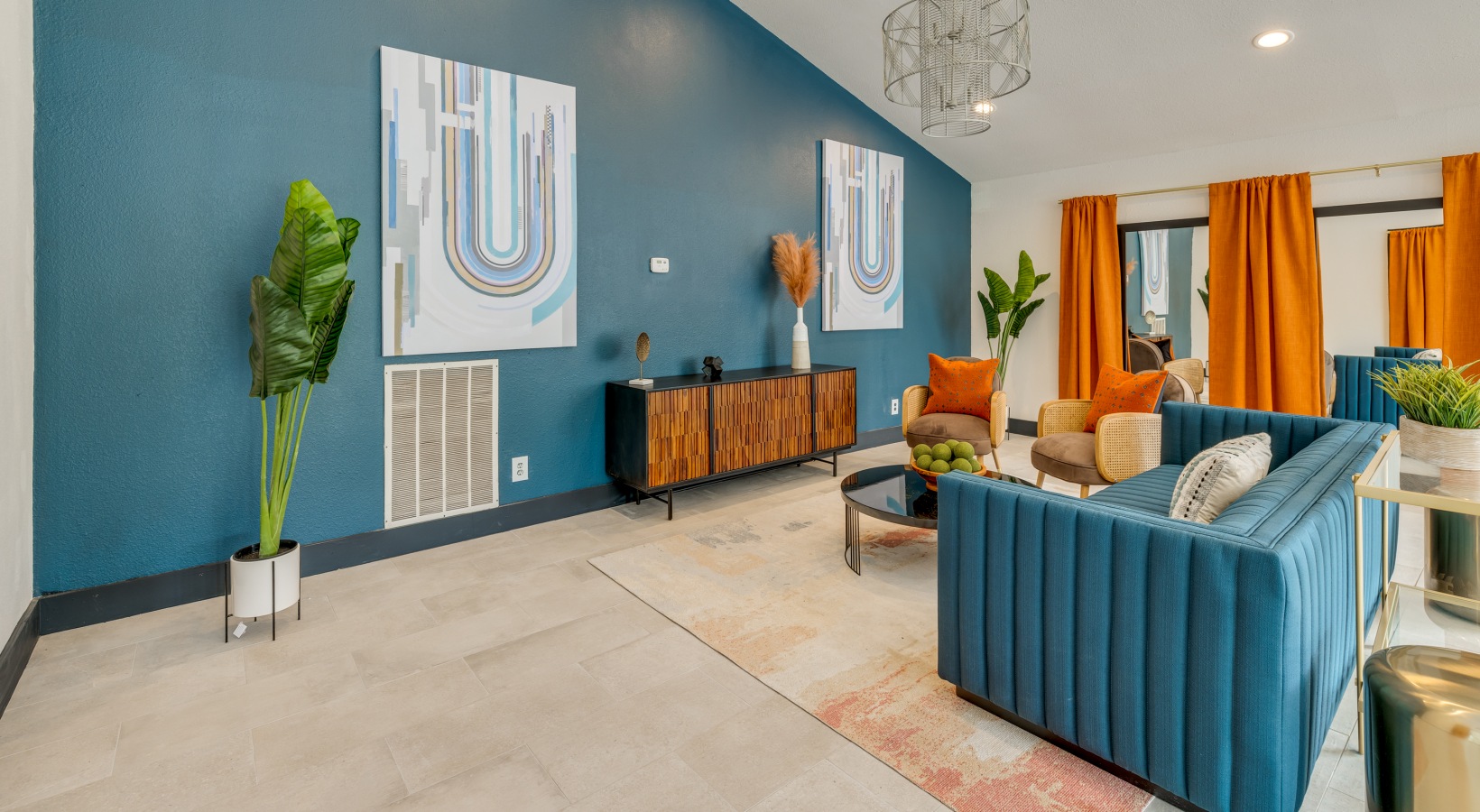 a living room with blue walls and orange accents at The  Tatum