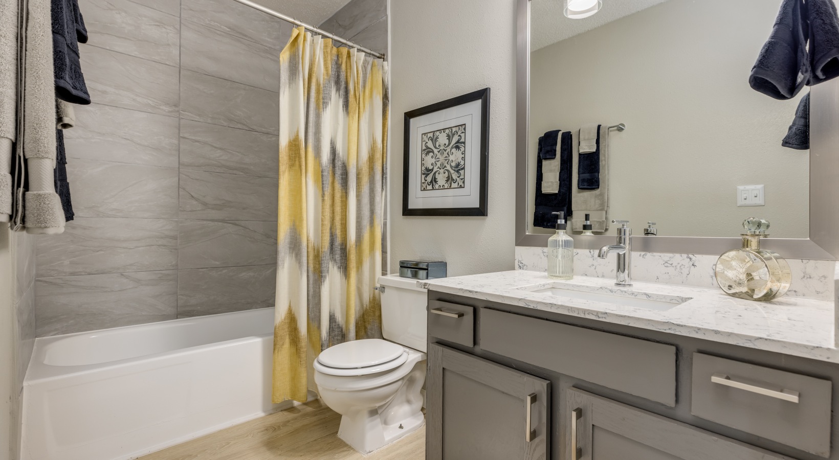 a bathroom with yellow and gray accents at The  Tatum